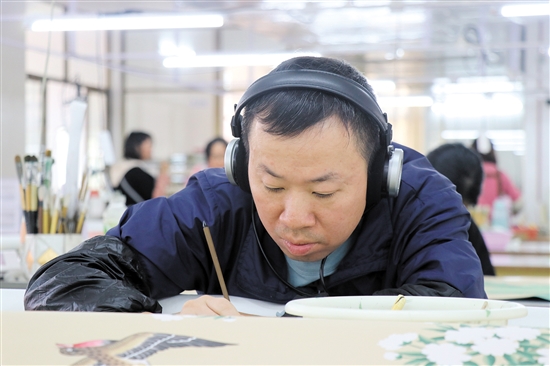 畫師戴著耳機(jī)，可以讓精神更專注。（受訪者供圖）