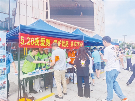 活動現(xiàn)場，工作人員向群眾宣傳愛路護路知識。
